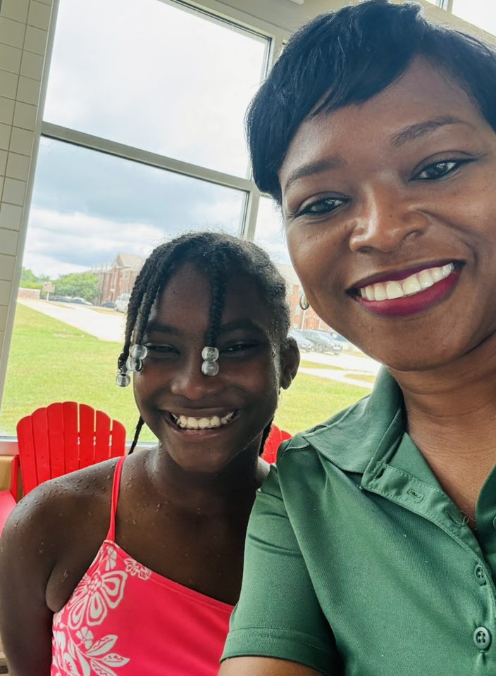 A girl and a woman posing for a picture.